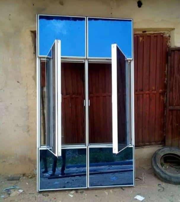 Aluminium window with blue reflective glass and open casement sashes