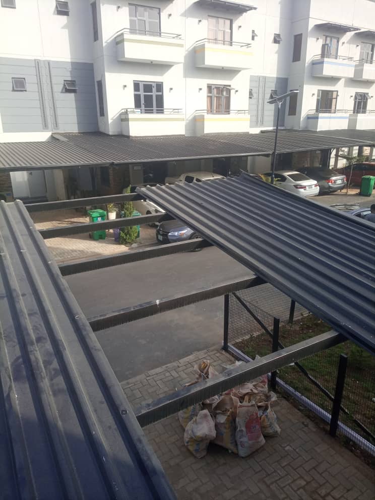 Row of grey carports in a residential car park