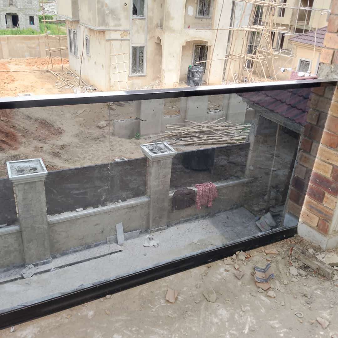 Tempered-glass balcony panel fitted on a building under construction