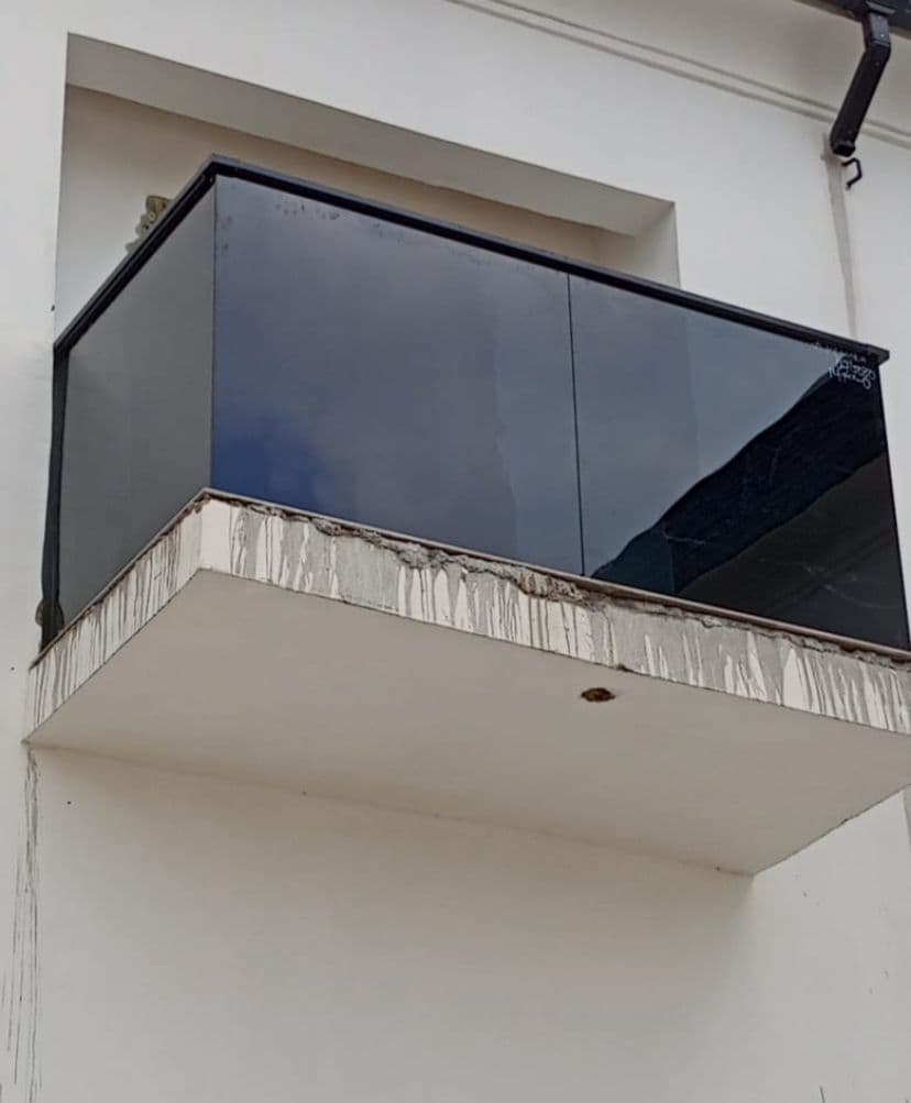 Dark tinted glass balcony on a white building