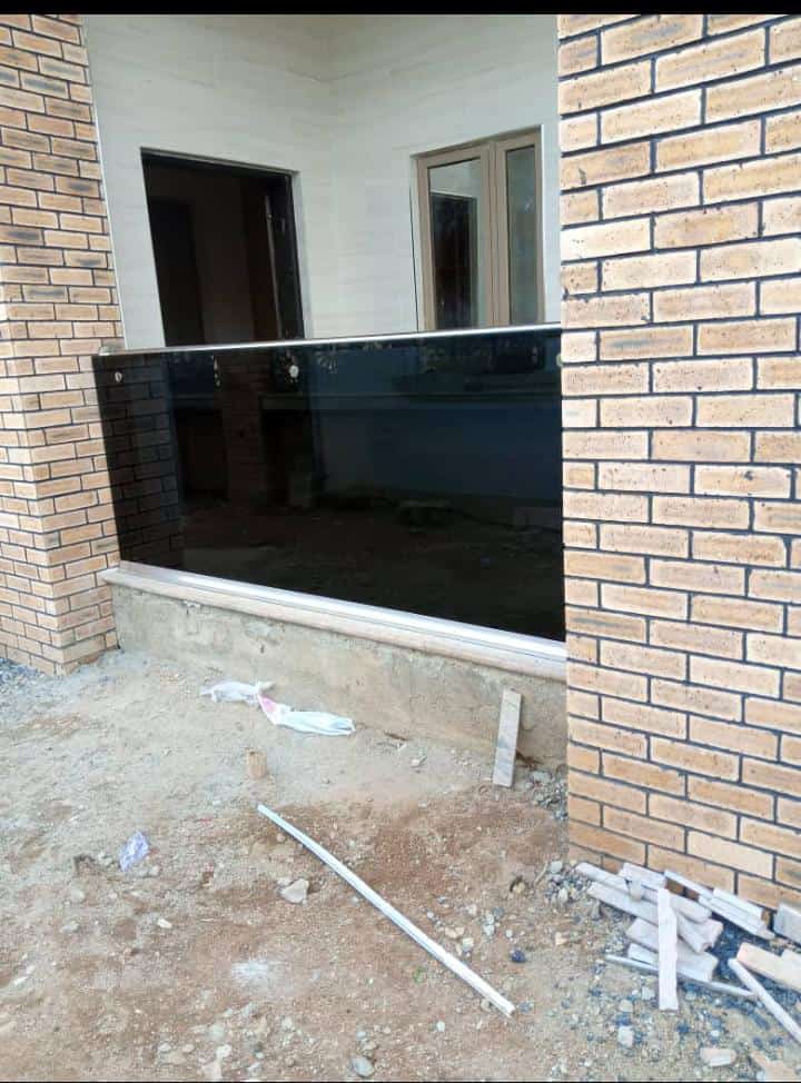 Tinted glass balustrade between brick walls on a new building
