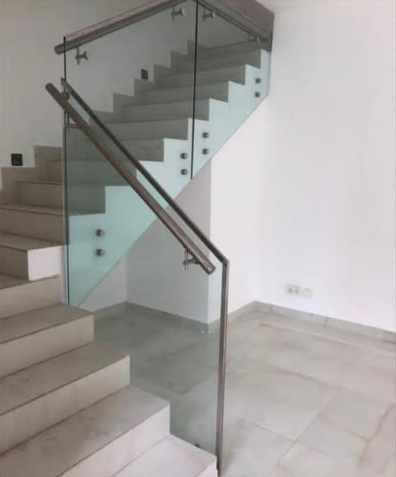 Glass staircase balustrade with a stainless-steel handrail