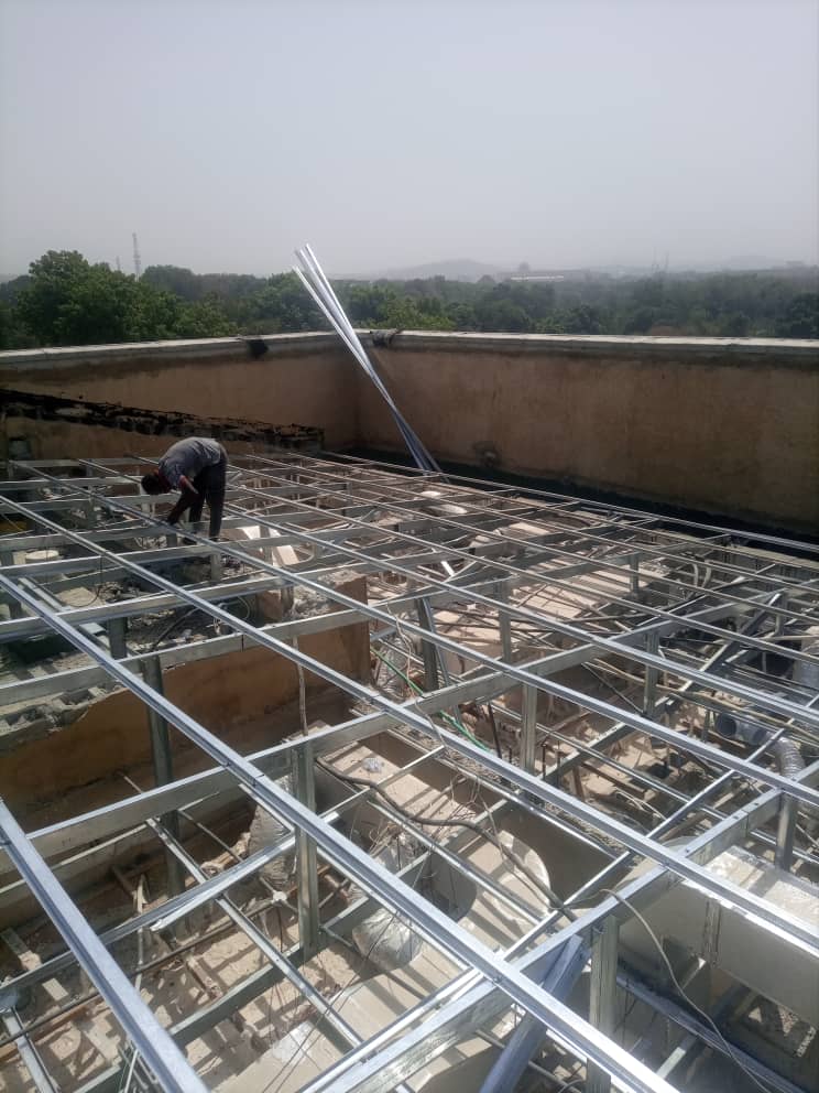 Metal roof framework being installed on a building