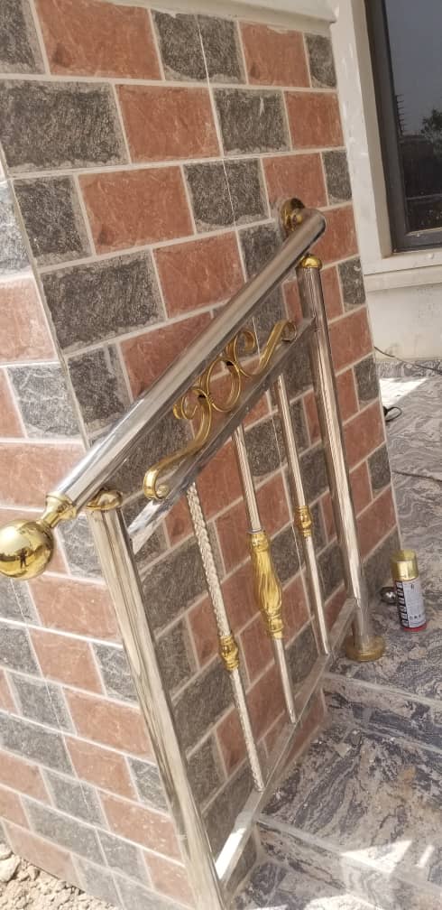 Gold-finish handrail beside entrance steps