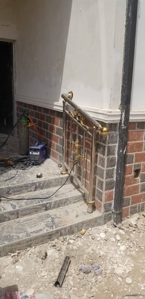 Gold-finish handrail on entrance steps
