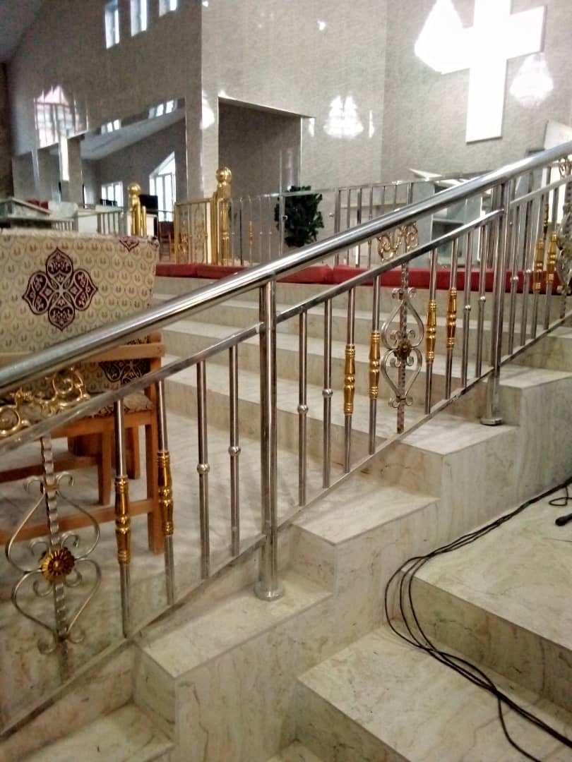Stainless-steel railings along steps in a large hall