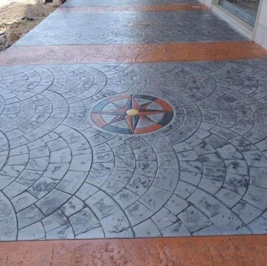 Stamped concrete walkway with a fan pattern and compass medallion