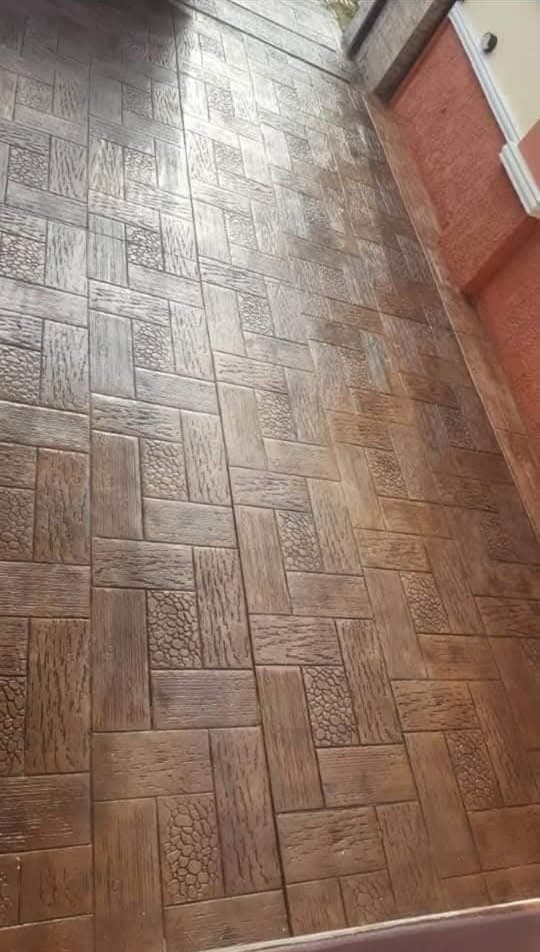 Brown stamped concrete floor with a wood-and-stone pattern