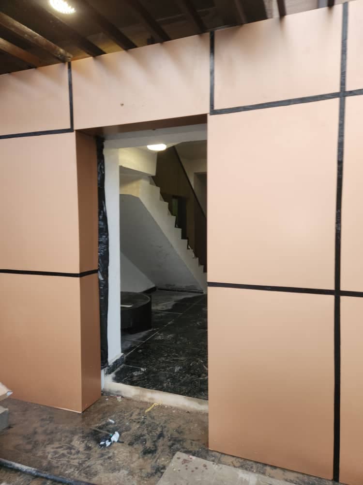 Bronze-colour composite cladding panels around a doorway