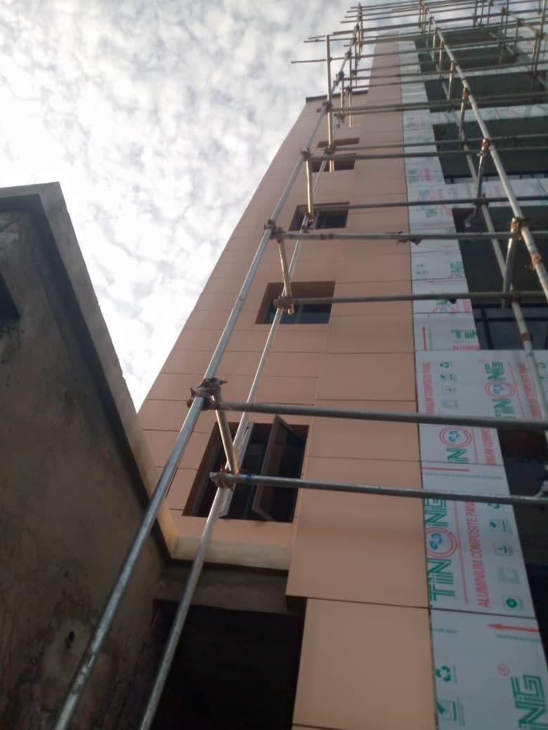 Copper-colour cladding on a tall building during installation