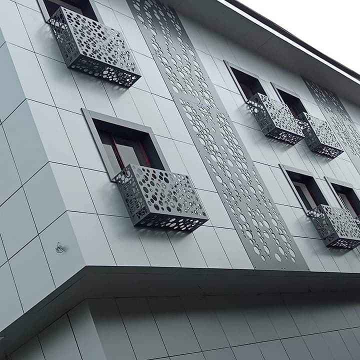 Grey cladding facade with perforated decorative panels