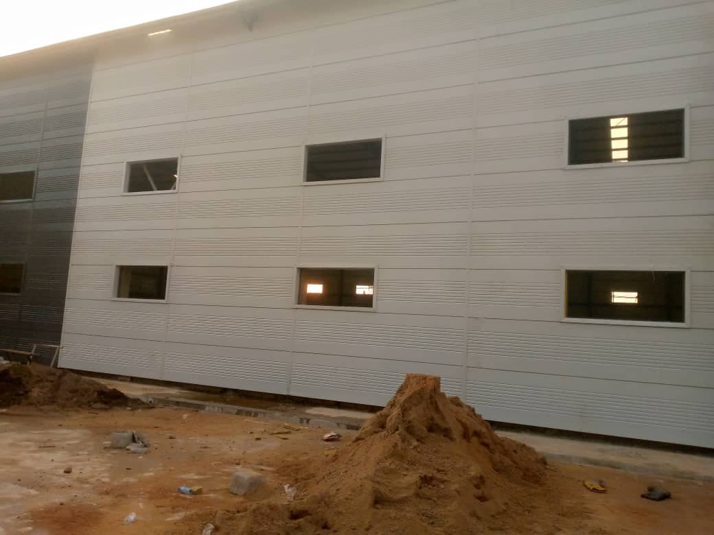 Long wall finished in grey cladding panels