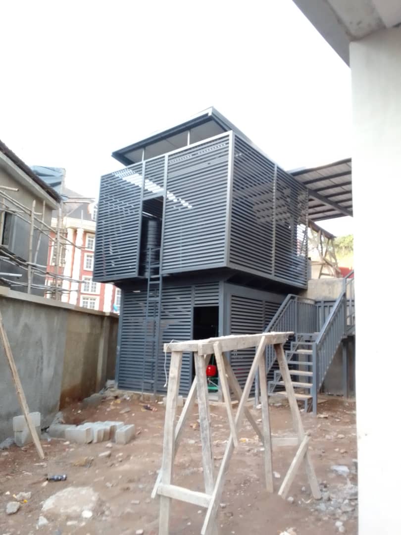 Structure wrapped in grey aluminium louvre cladding
