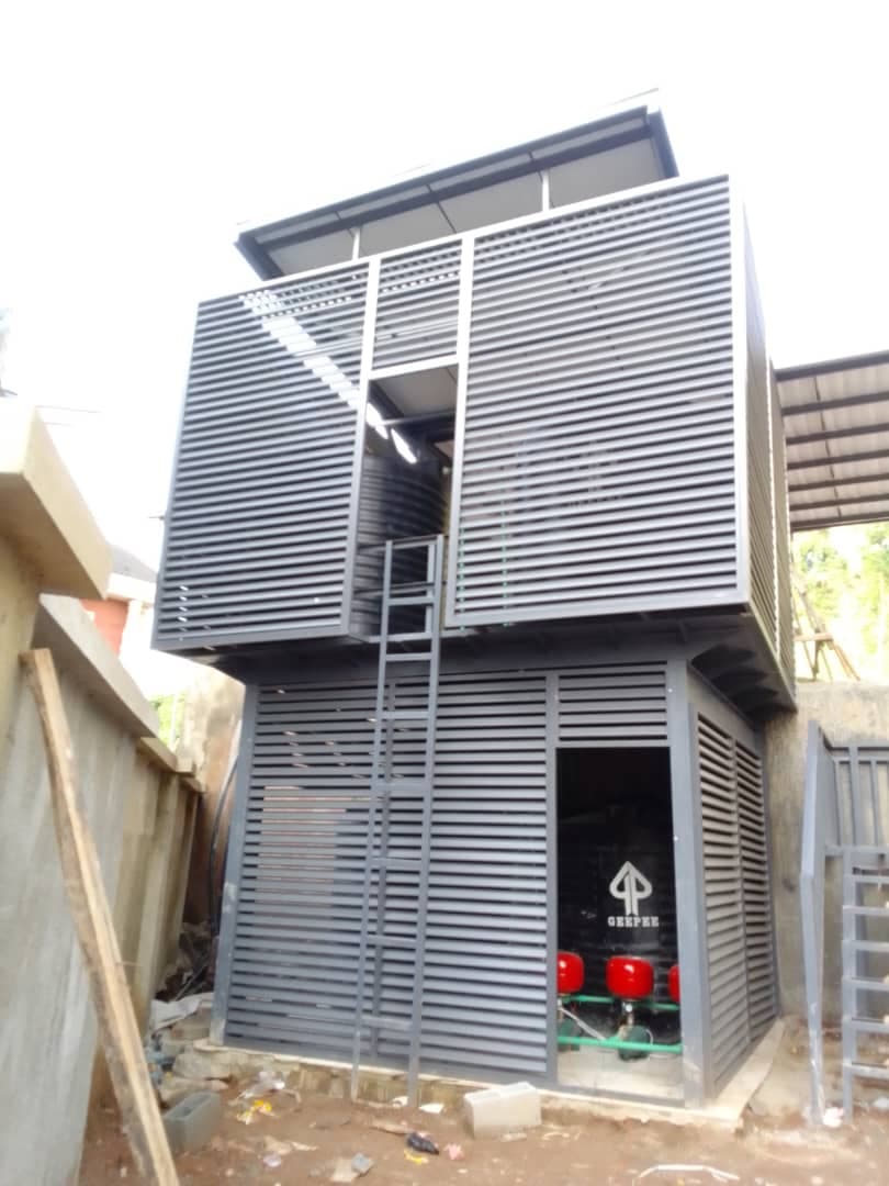 Grey louvre-clad structure with an access ladder