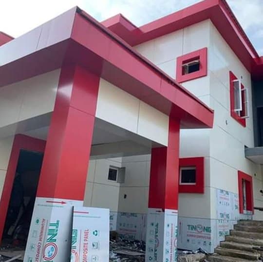 Building finished in red and white aluminium composite cladding