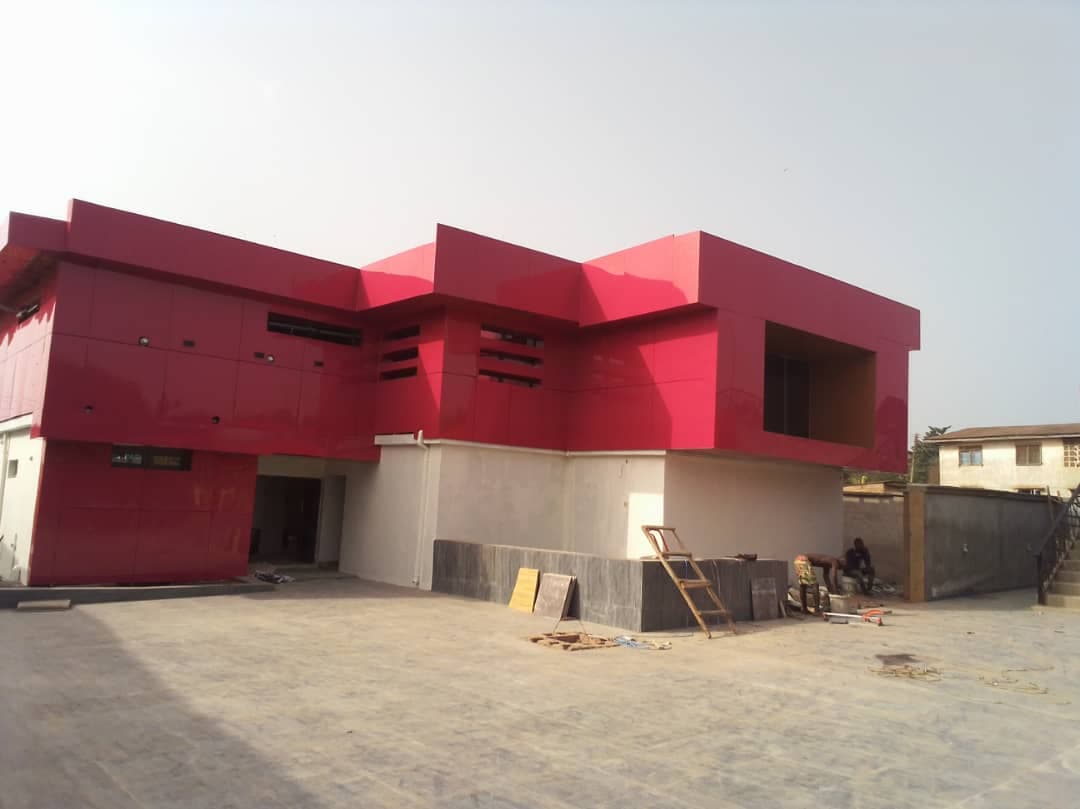 Two-storey building with red and white cladding