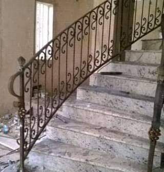 Curved wrought-iron staircase railing with scroll details