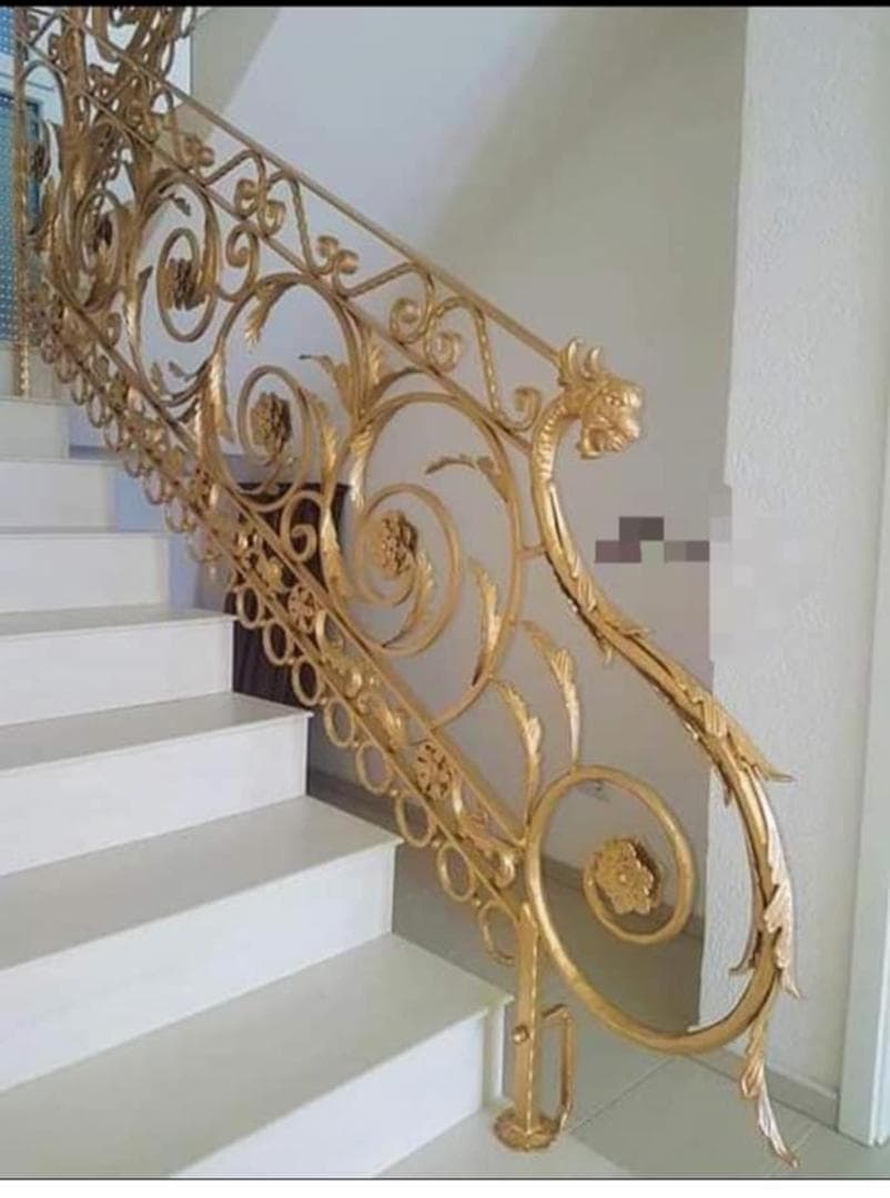 Gold ornamental wrought-iron staircase railing