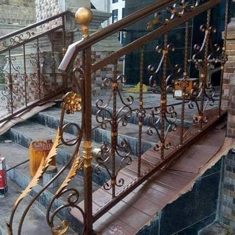 Bronze and gold wrought-iron railing on outdoor steps